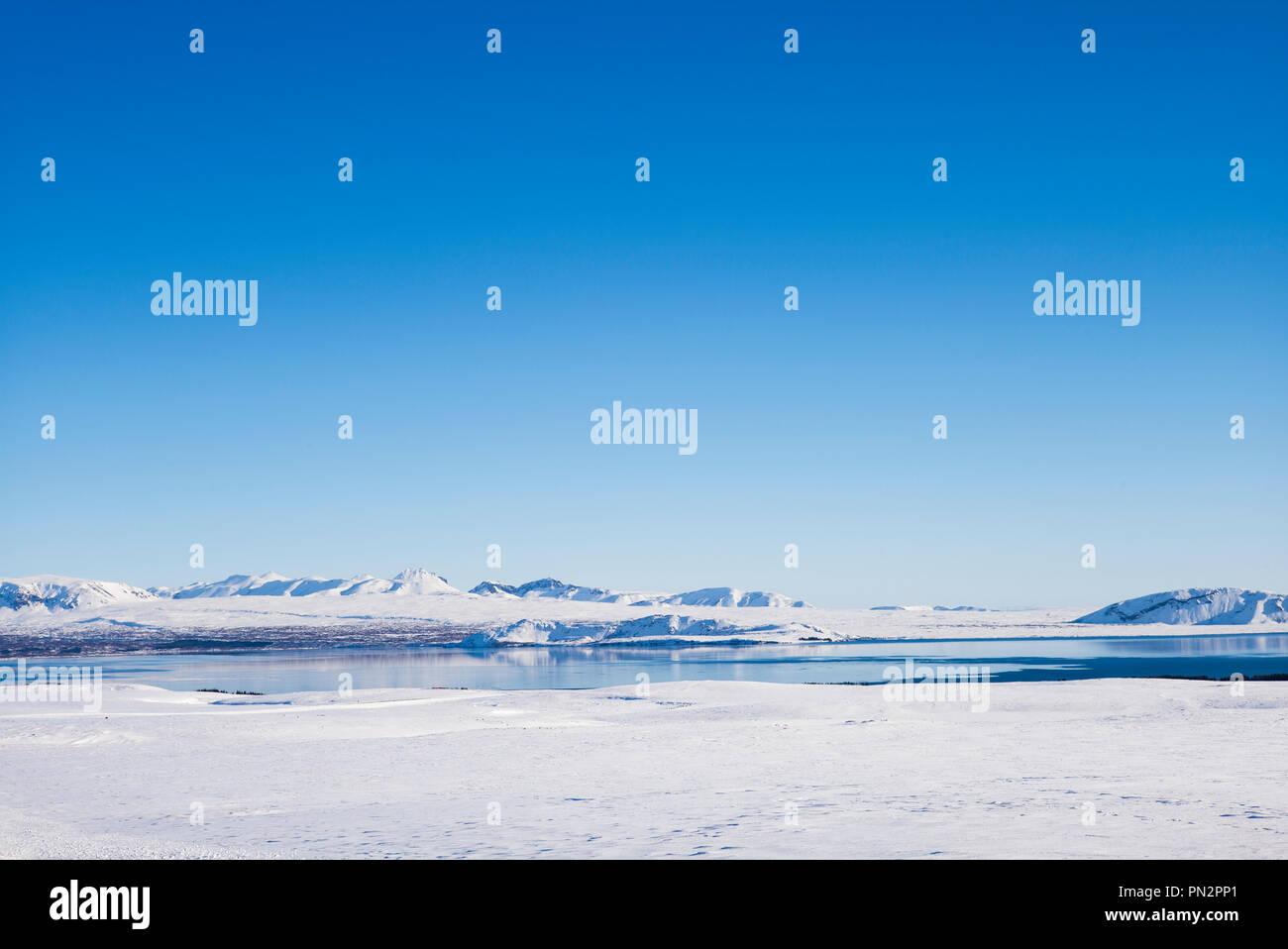 Snow-covered mountains and lake in stunning glacial landscape in South Iceland Stock Photo