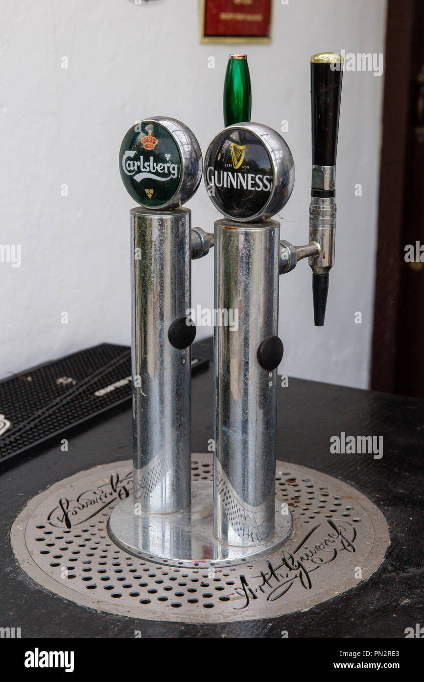 Guinness and Carlsberg beer bar taps Stock Photo - Alamy