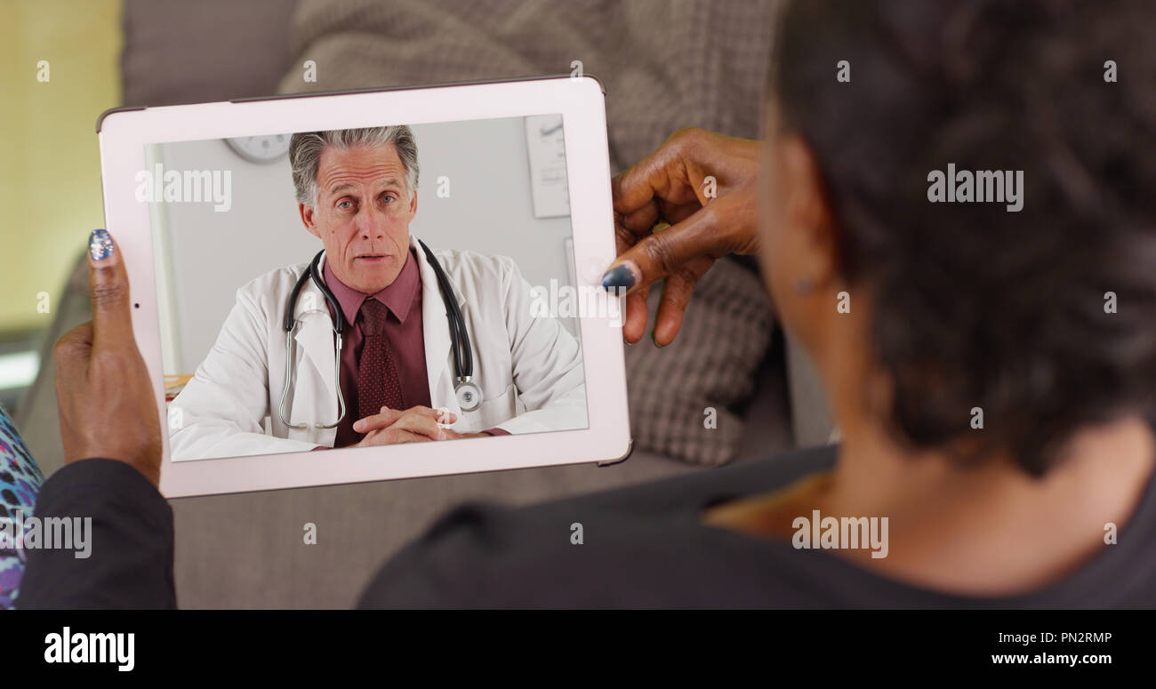 Doctor talking woman son hi-res stock photography and images - Alamy