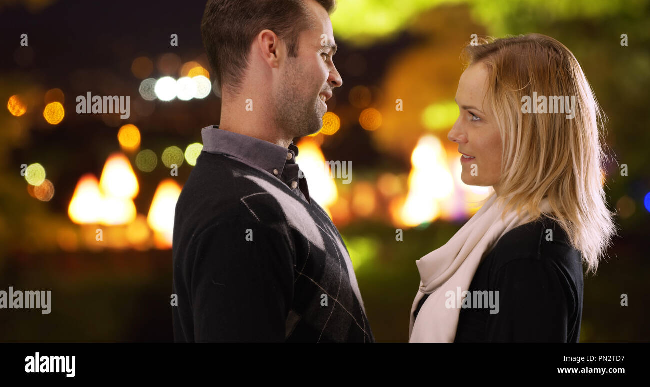 Loving young couple looking into each others eyes outdoors Stock Photo
