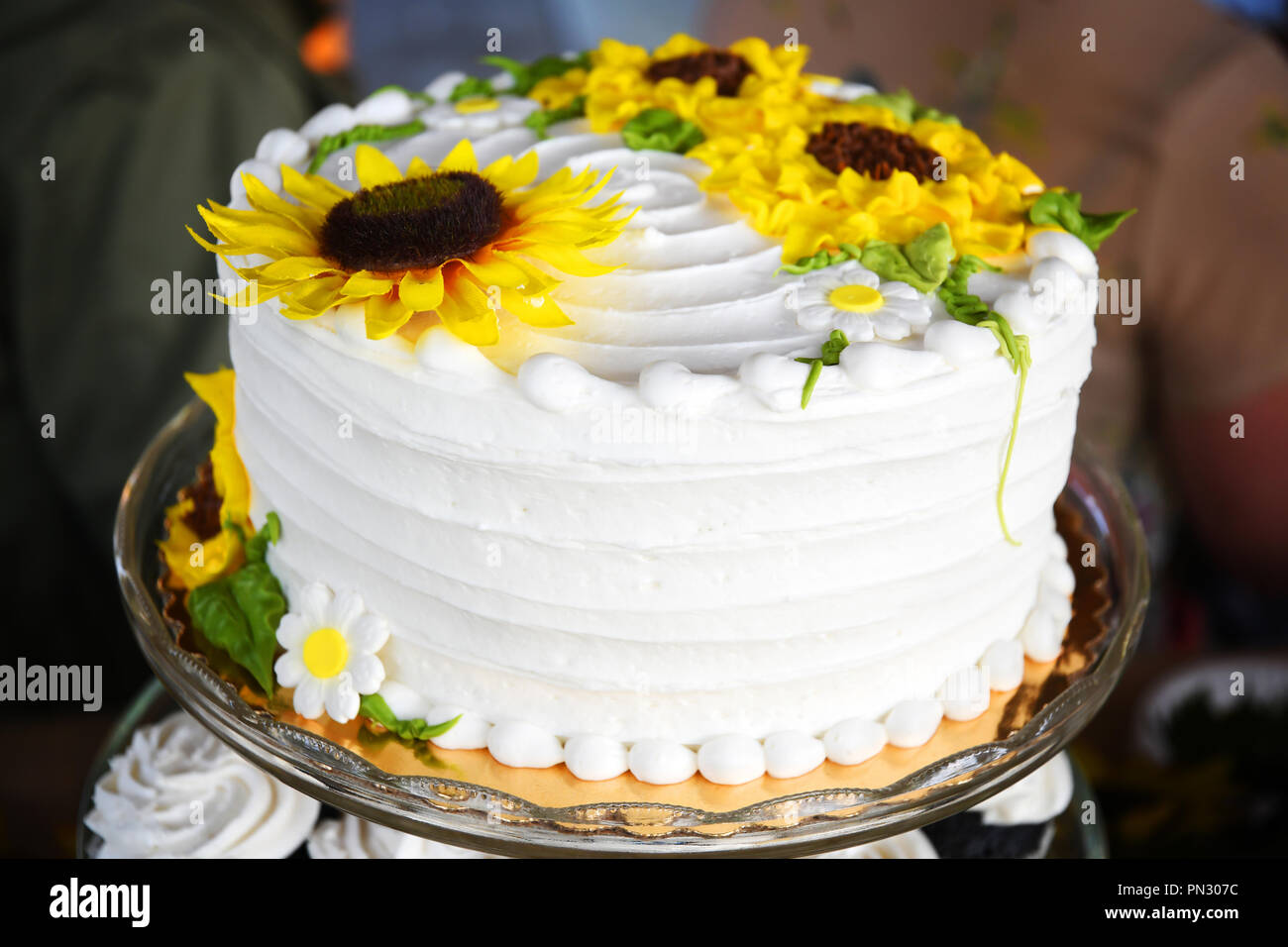 Wedding cake with white frosting and frosting sunflowers Stock Photo