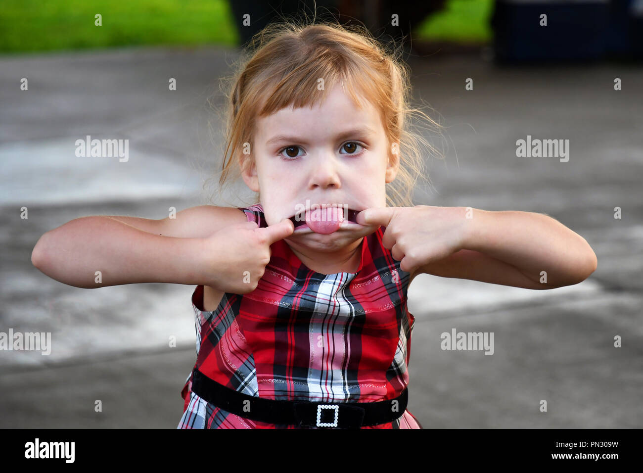 4-year-old girl making a silly face Stock Photo