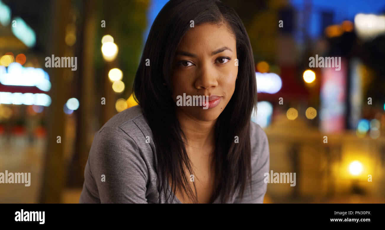 Casual portrait of pretty black woman on city street at night Stock ...