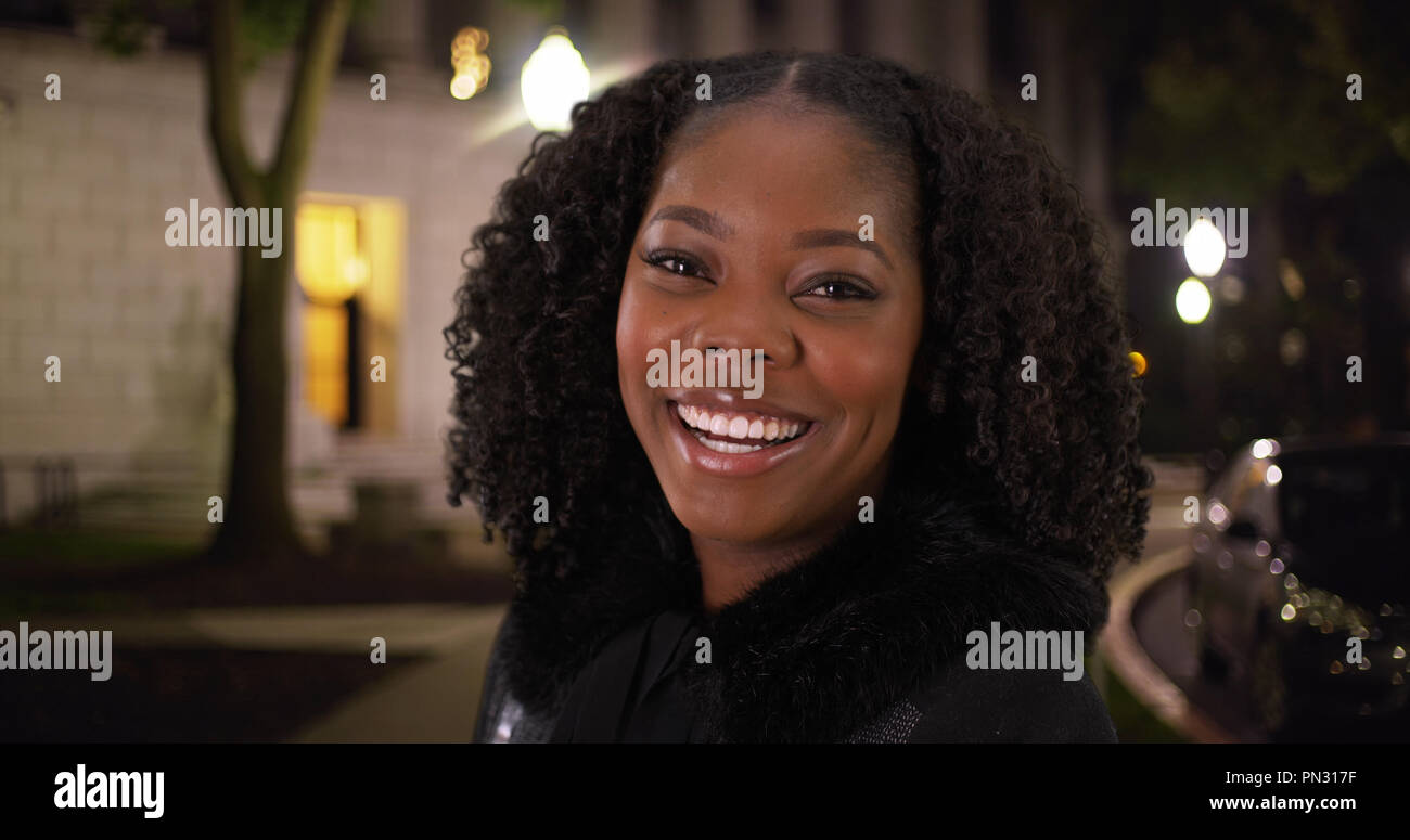 Close Up Of Cute Black Woman In Her 30s Laughing At Camera Outside