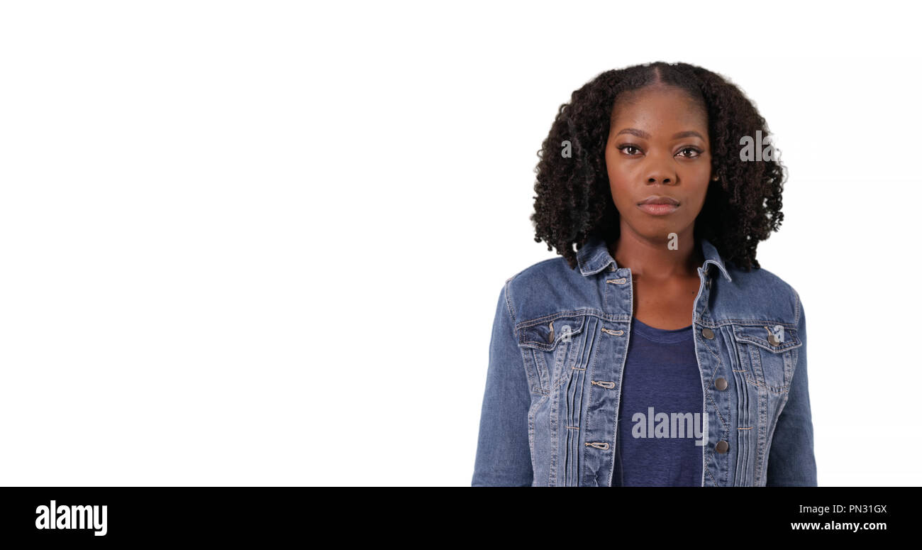Portrait of attractive black woman in jean jacket in studio with copyspace Stock Photo