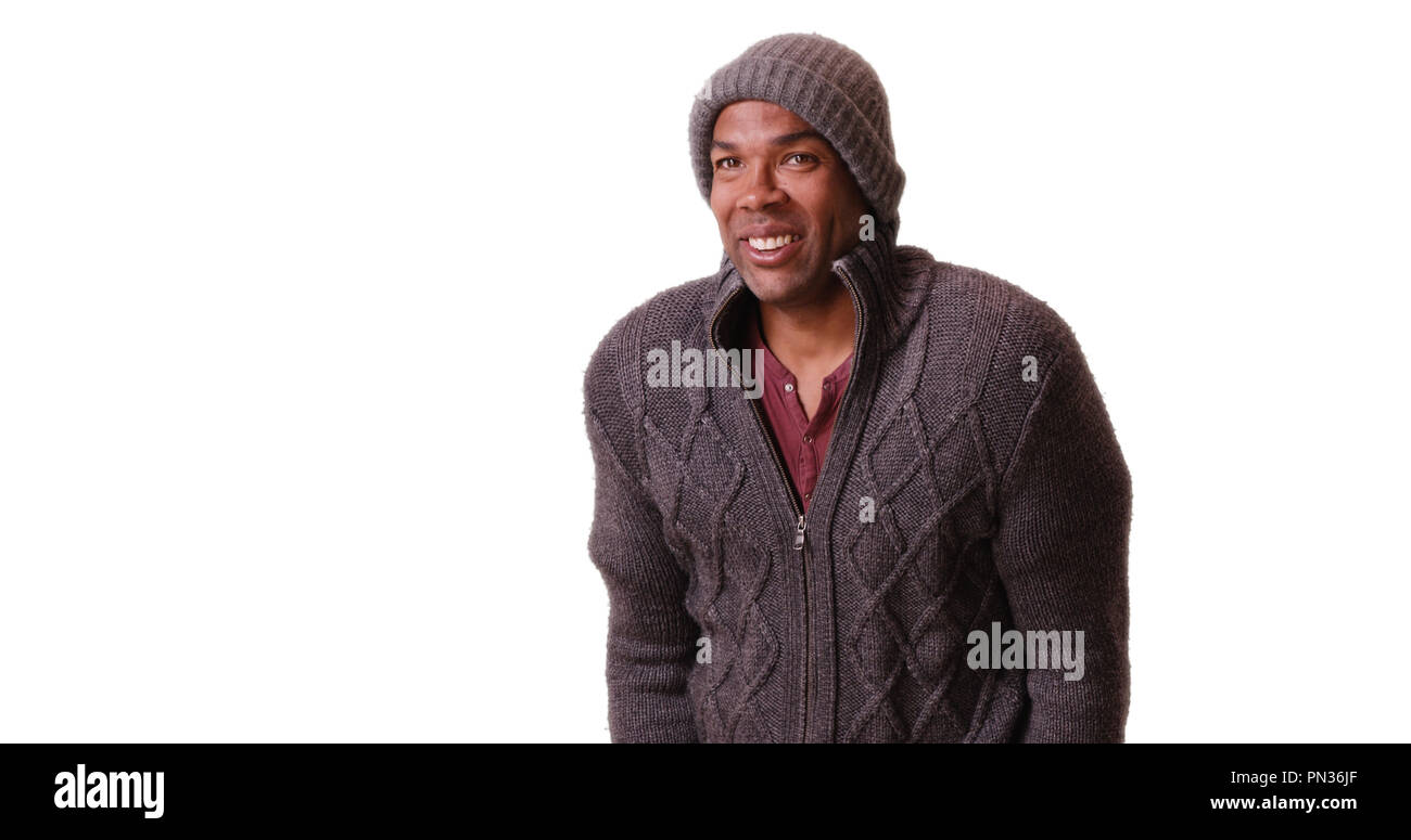 An African American man stands trembling on a white background Stock Photo