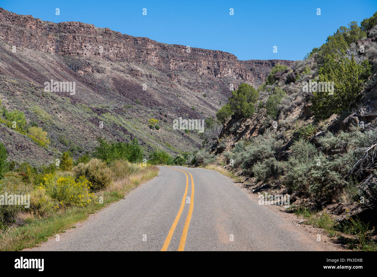 Road curves through the bottom of the Rio Grande Gorge in the Rio Grande del Norte National Monument near Taos, New Mexico Stock Photo