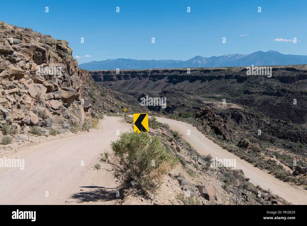 Directional road signs at a switchback on a dangerous dirt road at the
