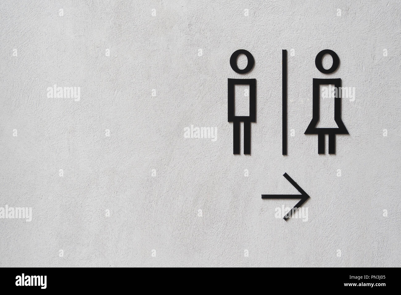 modern man and woman public toilet sign on the cement wall with copy