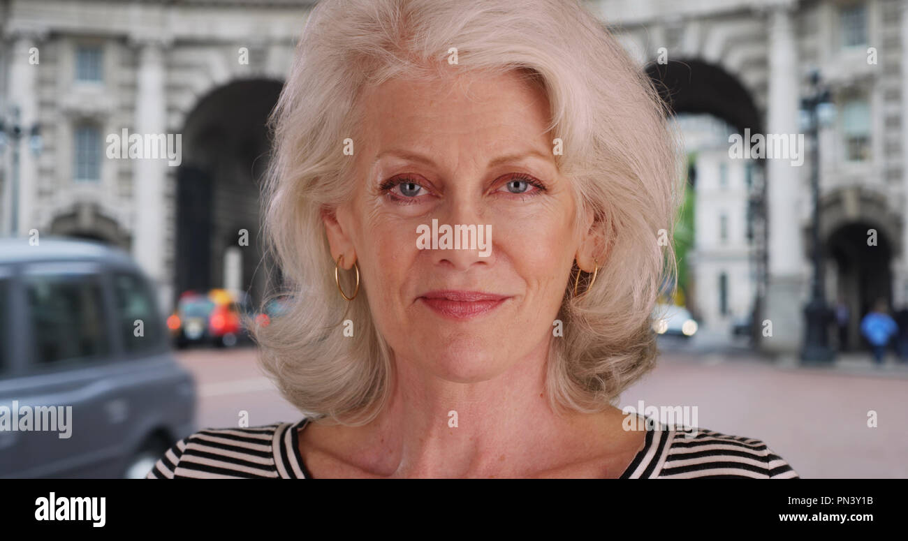 Close up of attractive older woman smiling in London England by Admiralty Arch Stock Photo