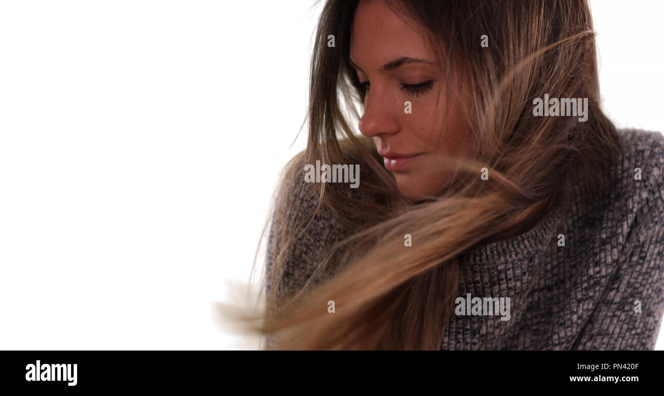 Beautiful woman with long brown hair blowing in the wind on white ...