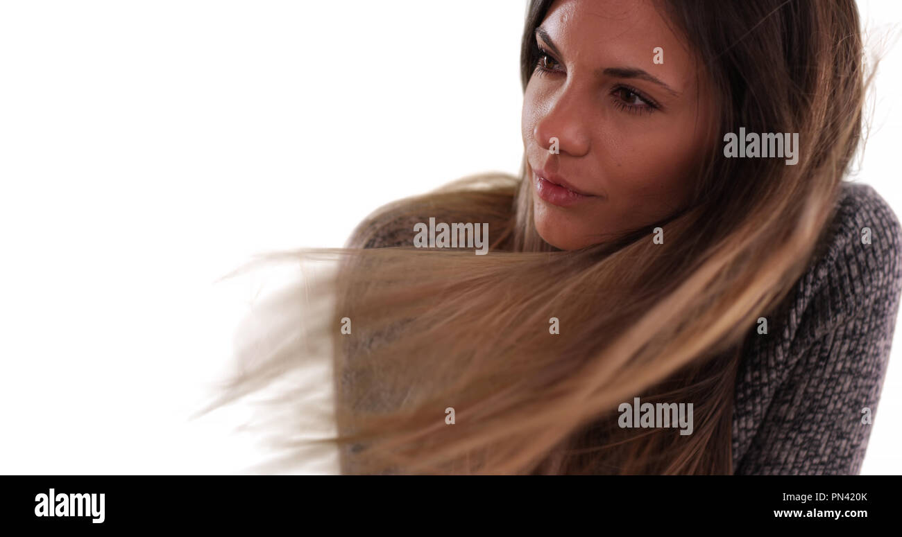 Beautiful woman with long brown hair blowing in the wind on white ...
