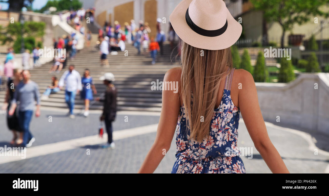 Rear shot of woman with outstretched arms feeling wind by Spanish Steps