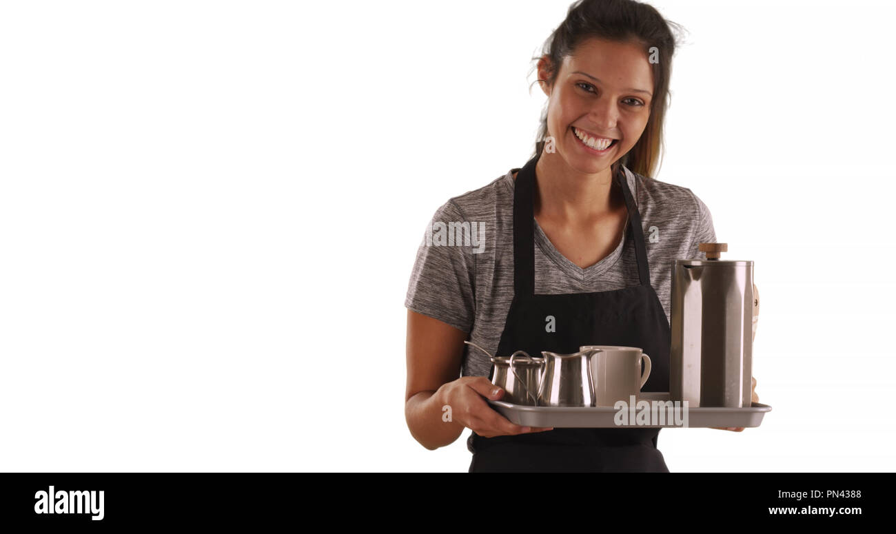 Pretty waitress carrying tray with coffee on white background with