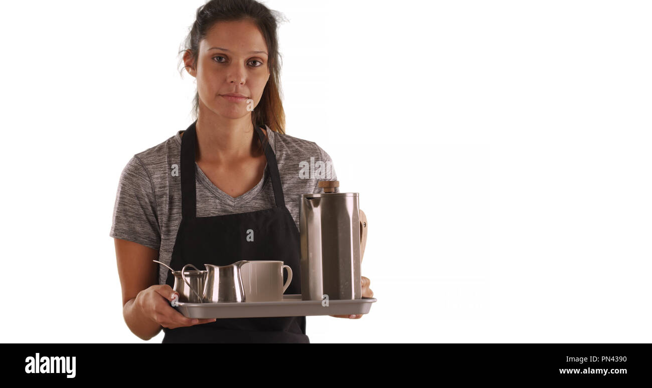 Serious waitress carrying tray with coffee beverages on white background Stock Photo