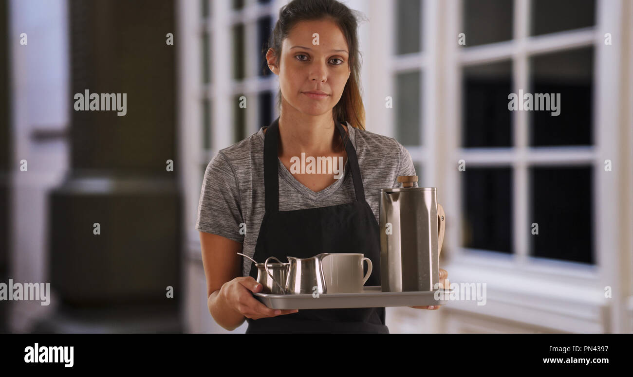 Portrait of unhappy waitress holding tray to serve drinks Stock Photo