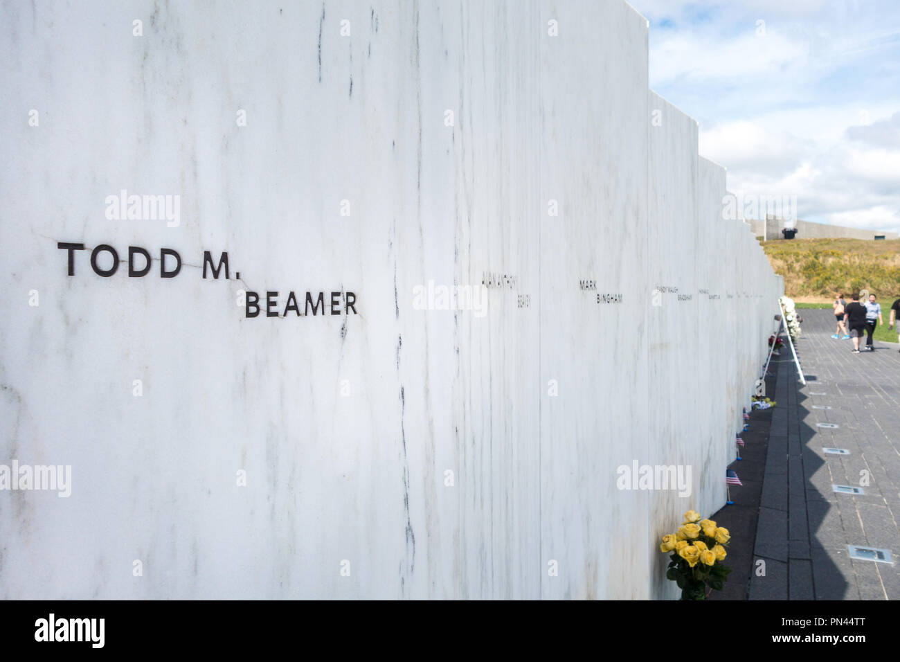 Visitors view the Wall of Names, located at the end of Memorial Plaza