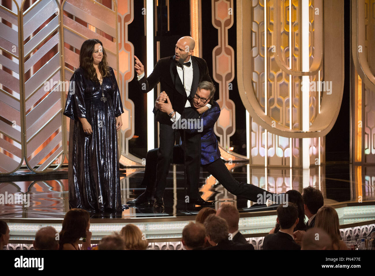 Presenters Melissa McCarthy, Jason Statham, and Paul Feig onstage at the 73rd Annual Golden Globe Awards at the Beverly Hilton in Beverly Hills, CA on Sunday, January 10, 2016. Stock Photo