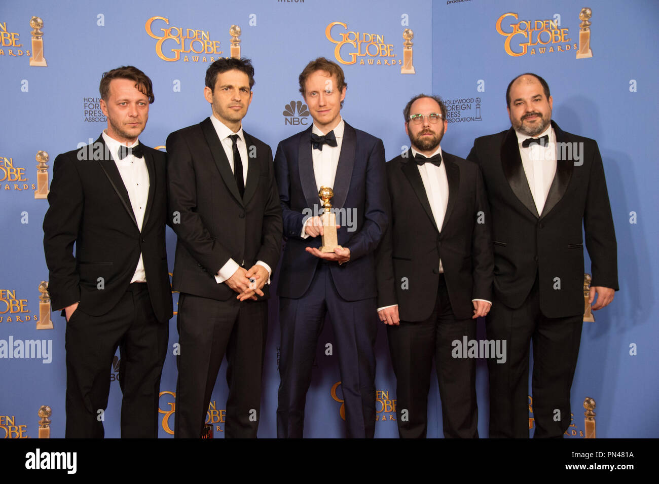 For BEST FOREIGN LANGUAGE FILM, the Golden Globe is awarded to “Son of Saul” (Hungary), directed by László Nemes. (L-R) Actors Levente Molnar and Geza Rohrig, director Laszlo Nemes, producers Gabor Sipos and Gabor Rajna pose with the award backstage in the press room at the 73rd Annual Golden Globe Awards at the Beverly Hilton in Beverly Hills, CA on Sunday, January 10, 2016. Stock Photo