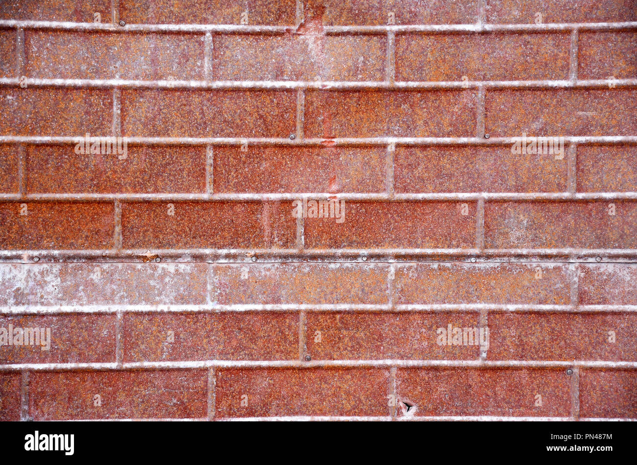 Rusty metal brick siding on a wall Stock Photo