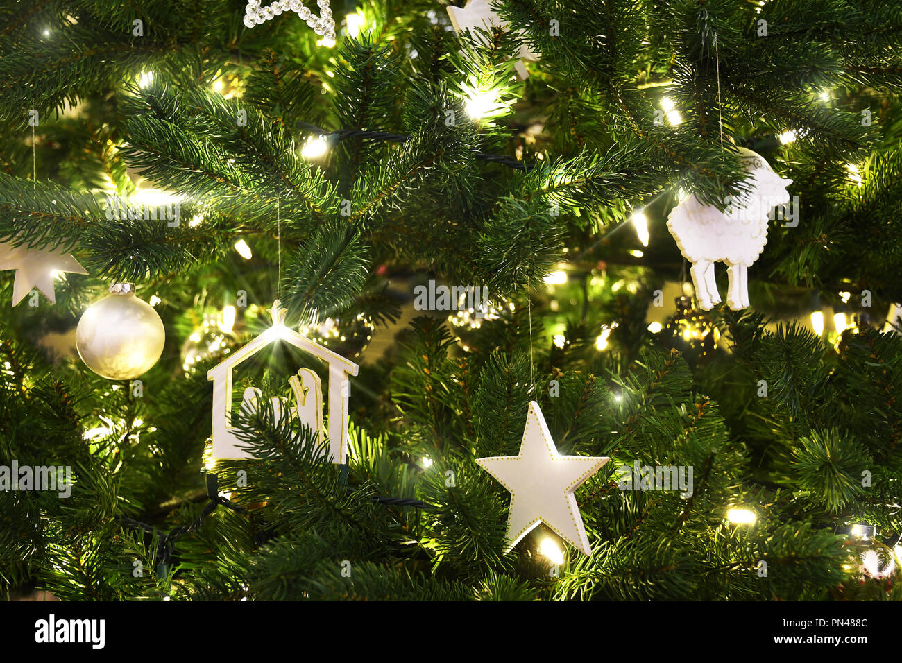 Closeup of a Christmas tree with white ornaments and lights Stock Photo ...