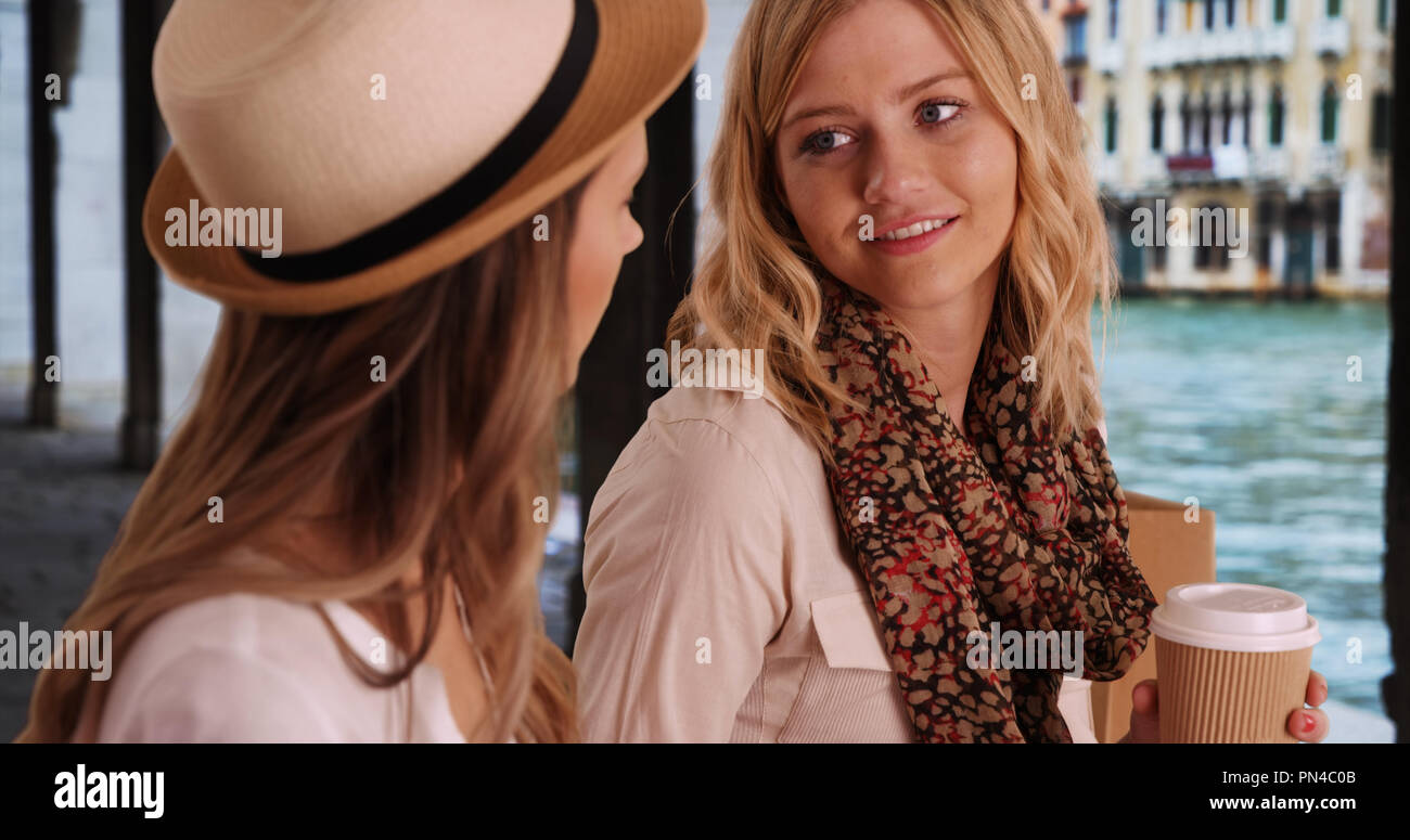 Pair of attractive Caucasian women chatting outside in Venice Italy Stock Photo