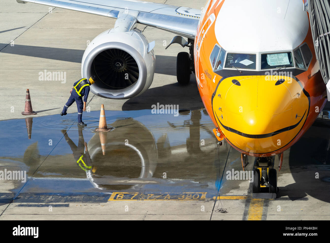 Bangkok, Thailand - September 19, 2018 : member ground crew worker checking aircraft turbine engine, air intake and fan blades of  Nok Air airplane be Stock Photo