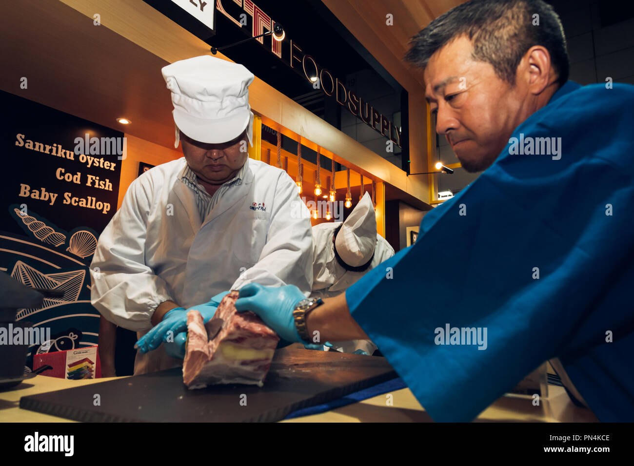 Tokyo, Japan - September 10, 2018 : japanese butchers are cutting and decorating highest meat grade of marbling A5 japanese wagyu beef for barbecue or Stock Photo