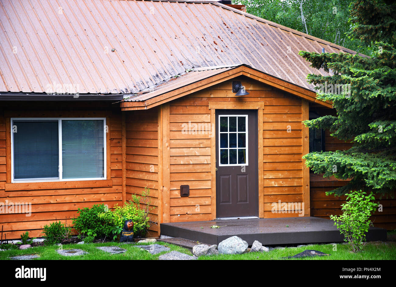 Front of rental cabin with cedar plank siding Stock Photo