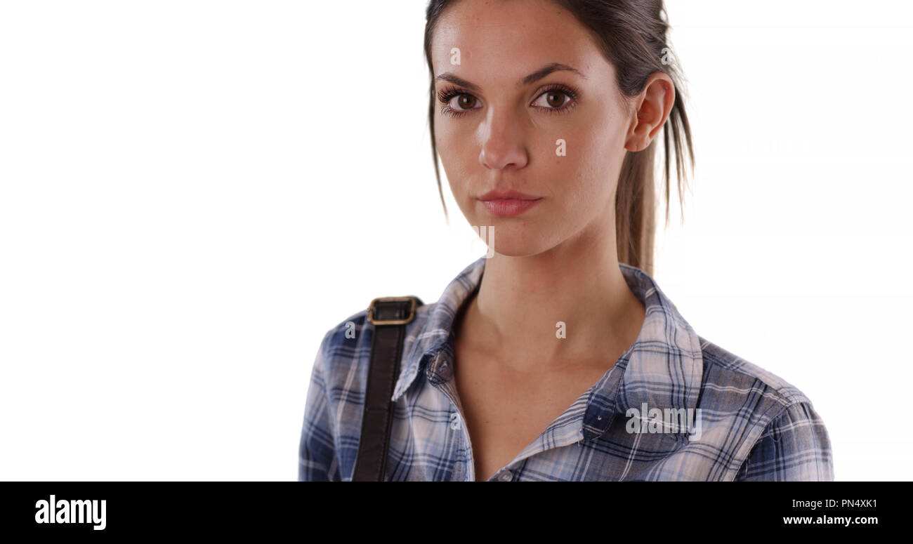 Portrait of pretty young woman in blue plaid shirt on solid white copy space Stock Photo