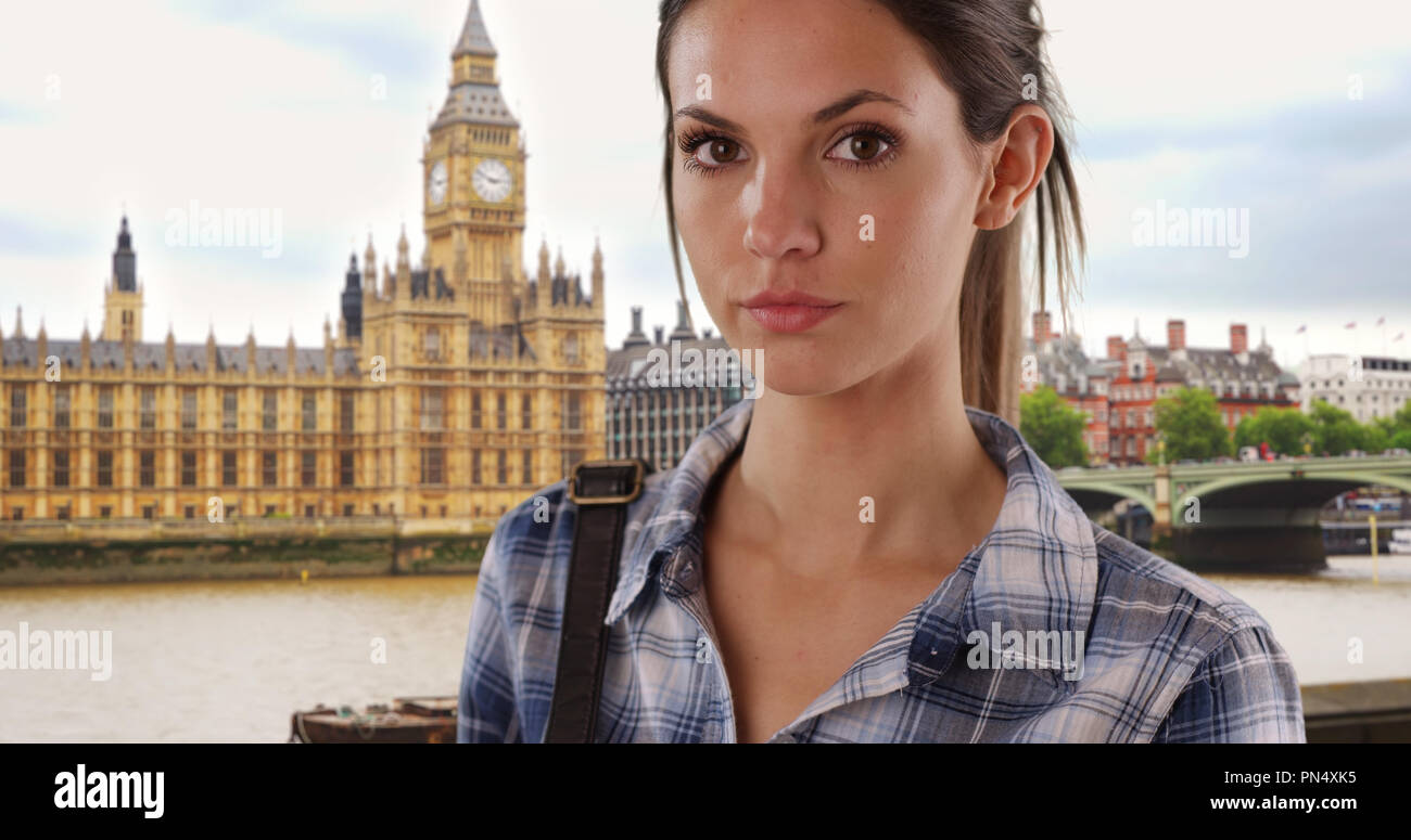 Beautiful young lady in her 20s wearing casual clothes by Big Ben in London Stock Photo