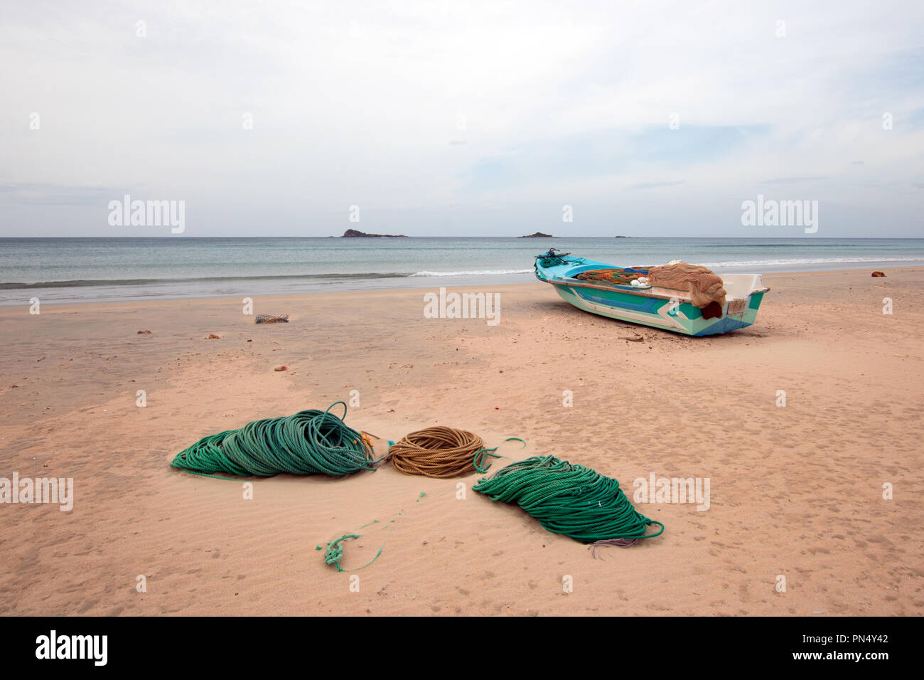 Deep sea fishing boat next to ropes and nets on Nilaveli Beach in  Trincomalee state in Sri Lanka Asia Stock Photo - Alamy