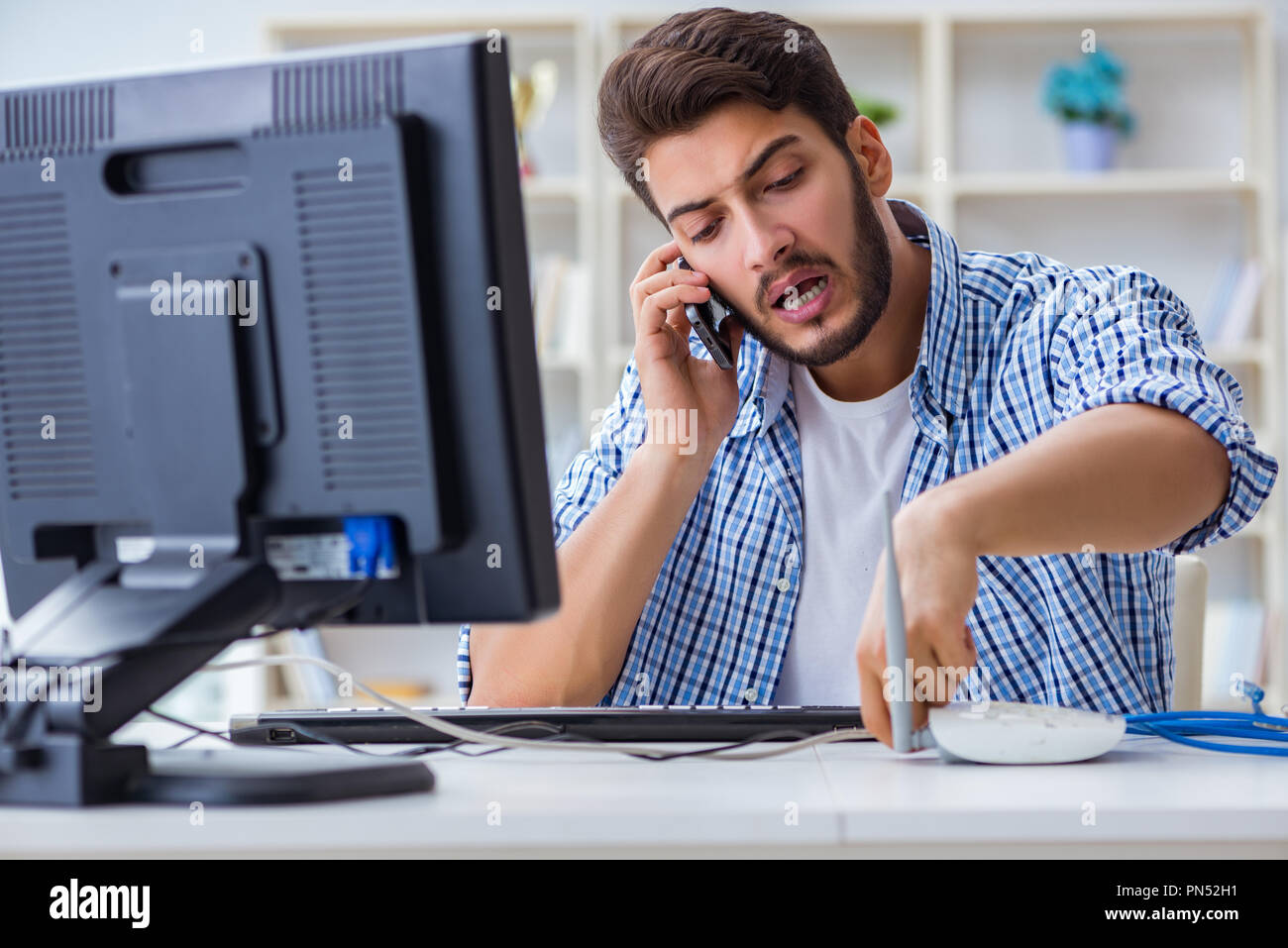 Frustrated young man due to weak internet reception Stock Photo - Alamy