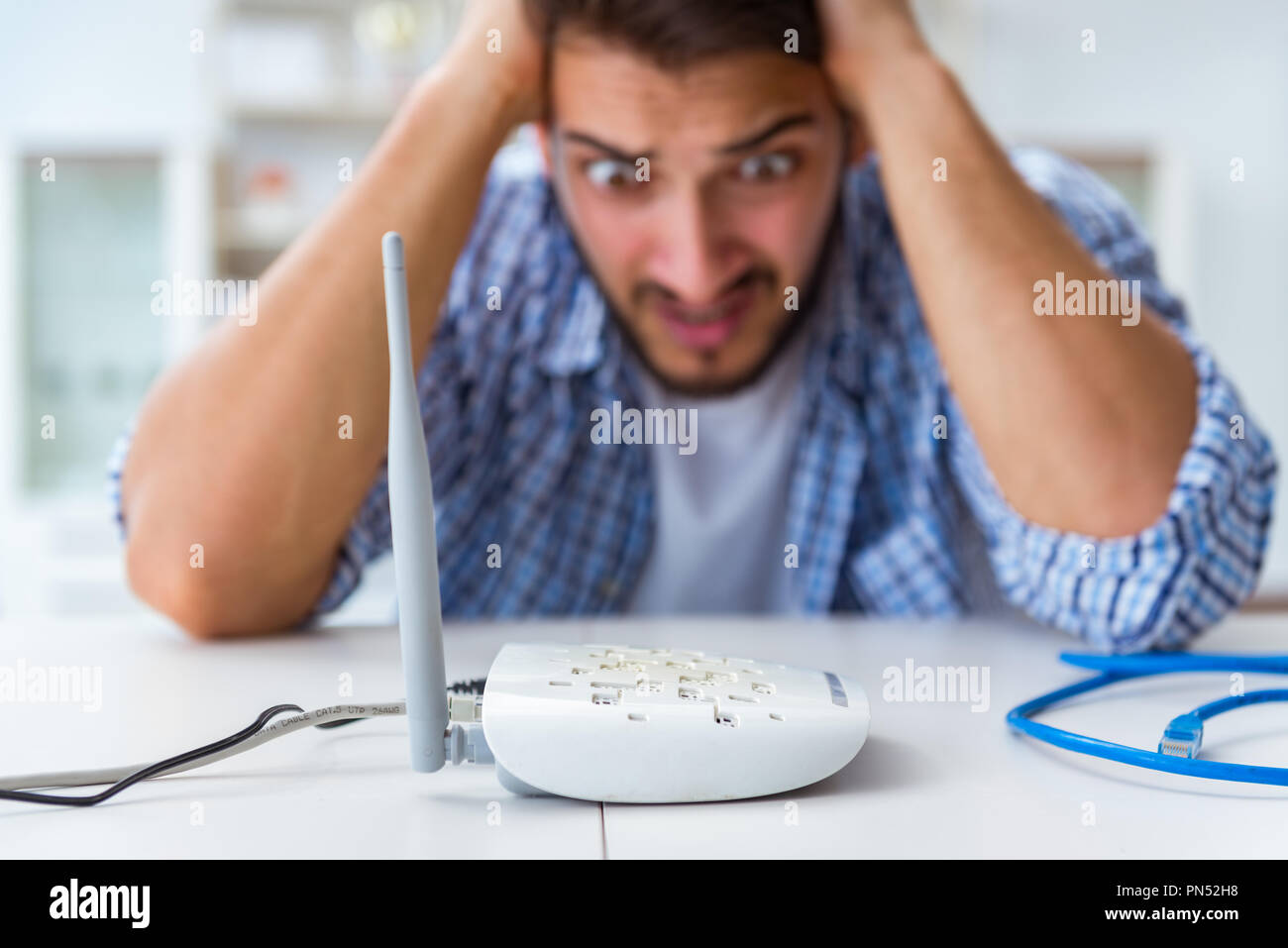 Frustrated young man due to weak internet reception Stock Photo - Alamy