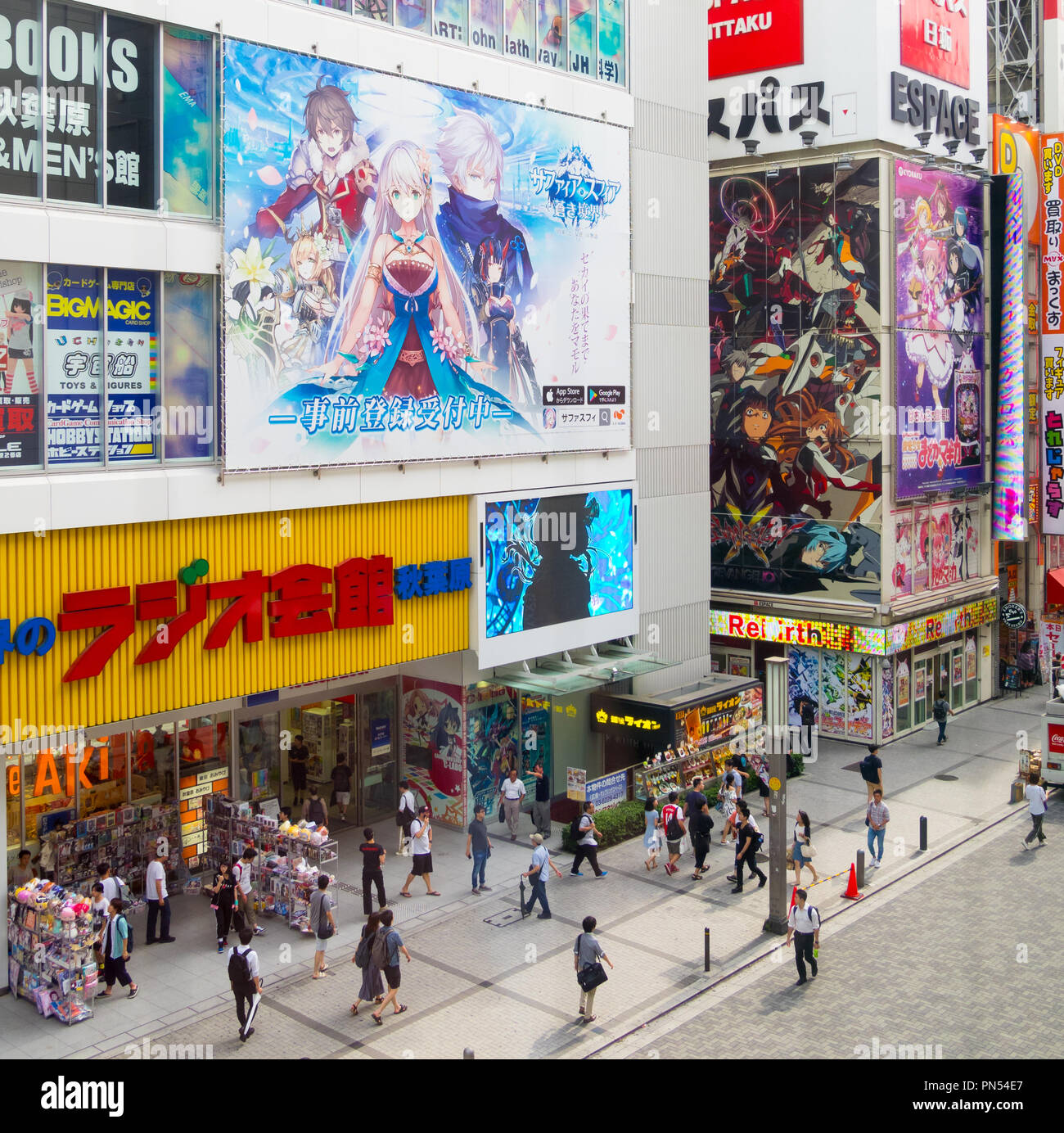 A view of tourists, anime bookshops and signs in the Akihabara district of Tokyo, Japan. Stock Photo
