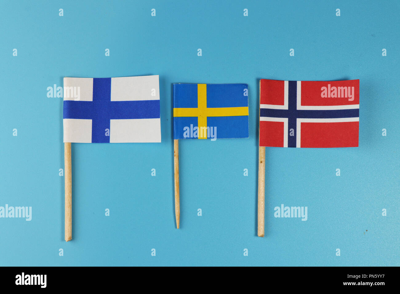 A states of North Europe. Scandinavia states and their flags Norway, Findland and Sweden. Blue background Stock Photo