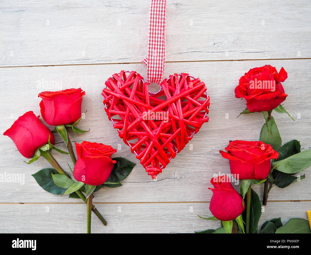 Romantic background with red rose, heart on wood table, top view Stock ...