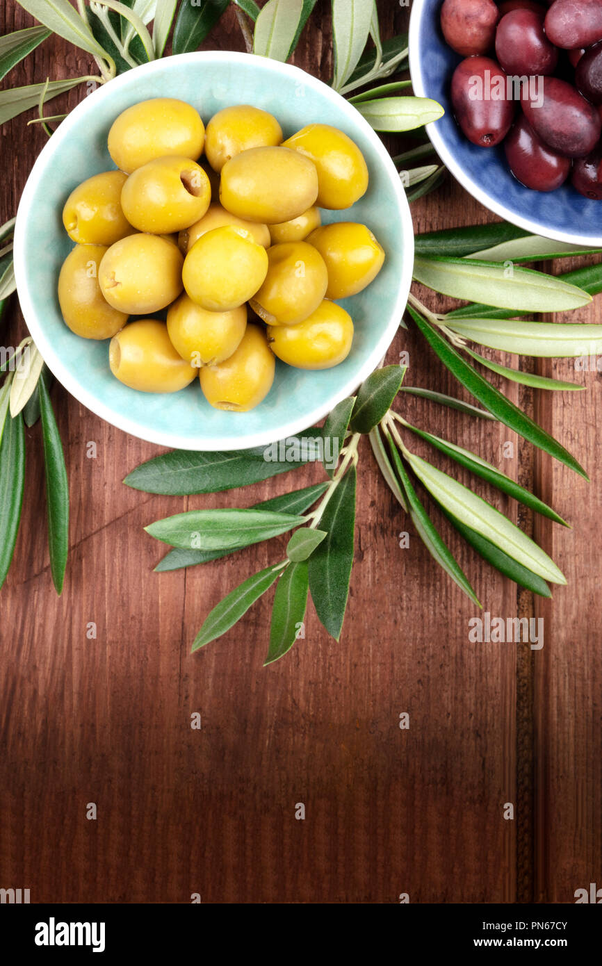 Overhead photo of various olives in bowls with a place for text Stock Photo