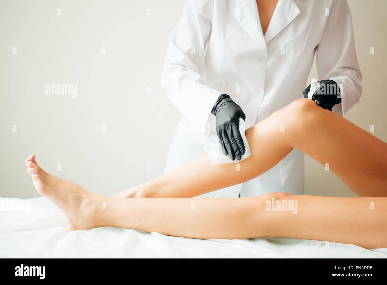 Preparing leg for paraffin wax bath in beauty salon Stock Photo