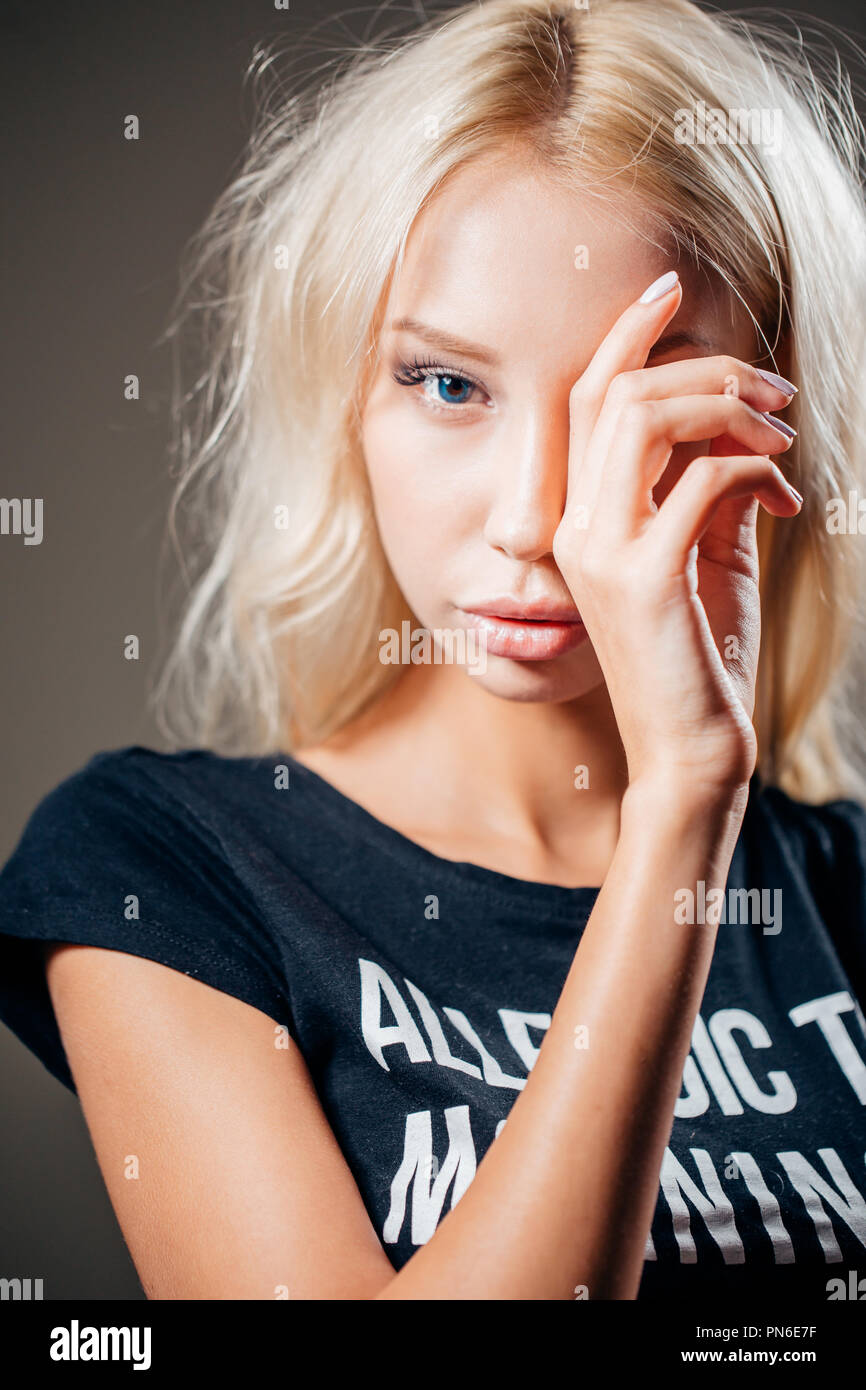 Beautiful woman with hand over eye, portrait. Stock Photo