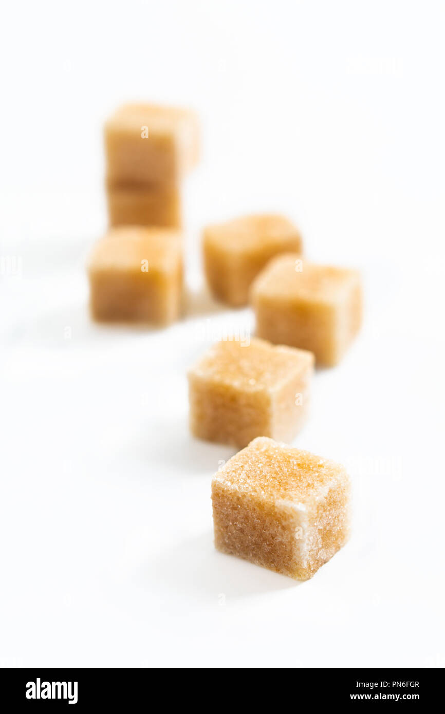 Food Spot focus organic Brown sugar cane cubes on white background Stock Photo Alamy