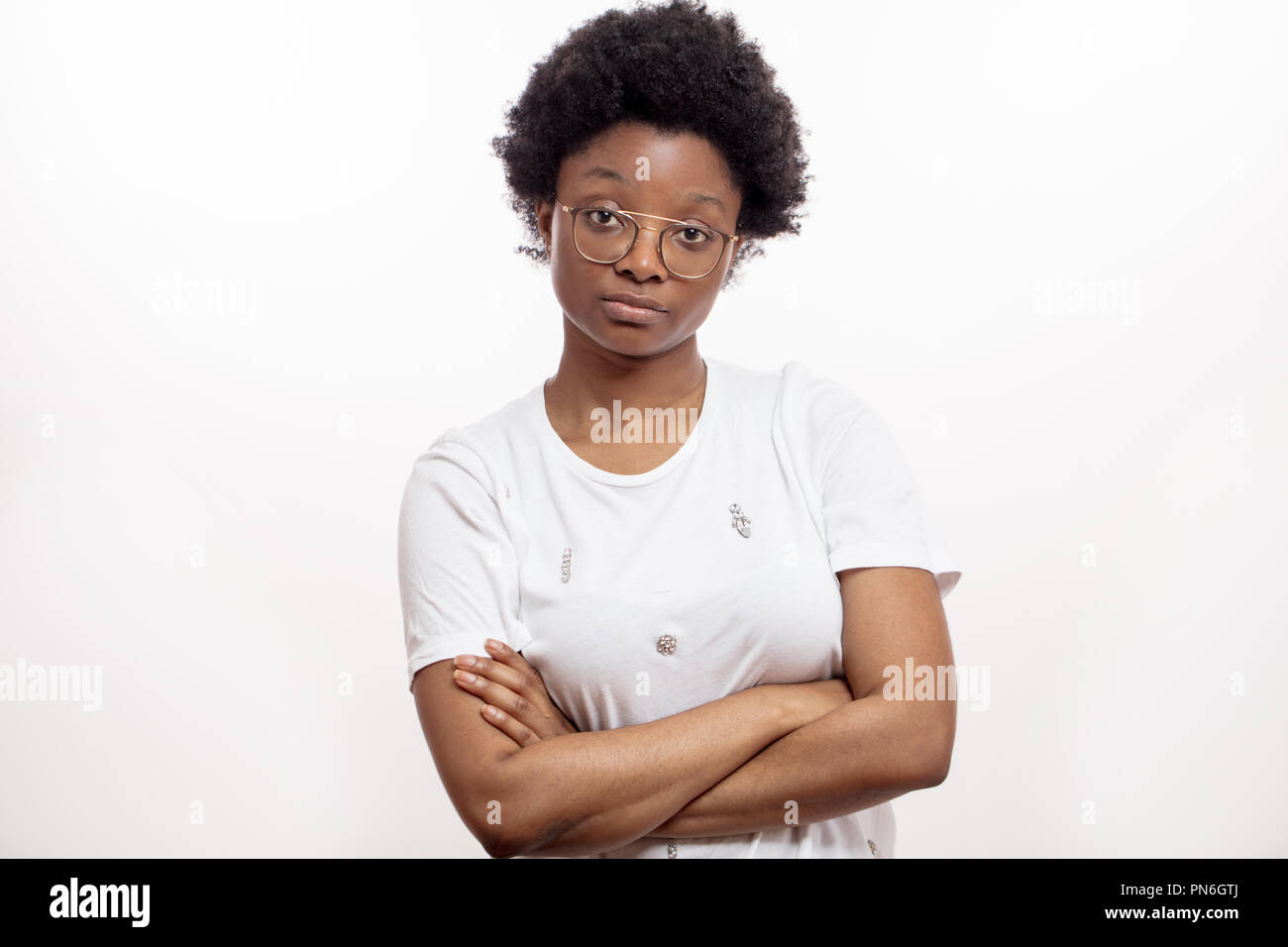 confident Afro female with crossed arms looking at the cmaera Stock Photo
