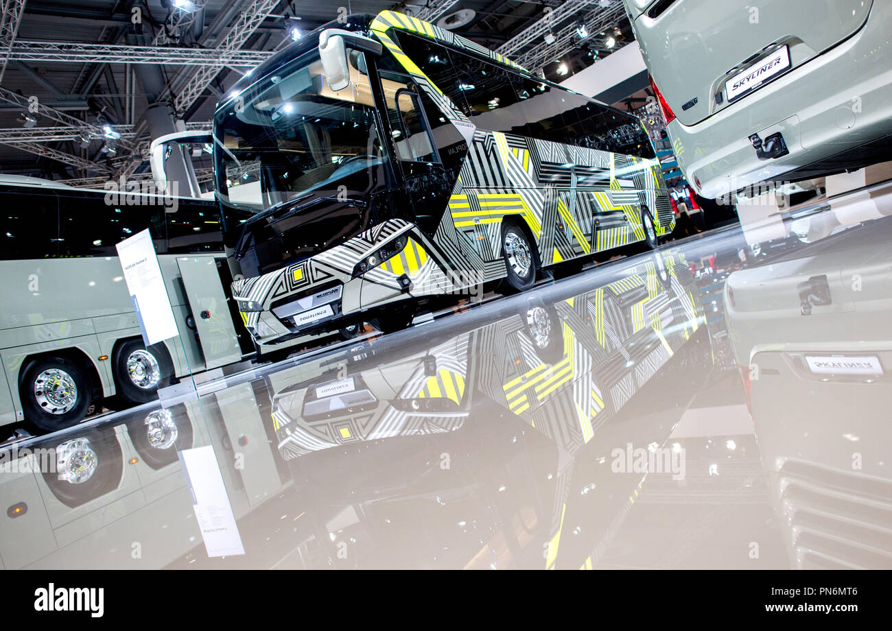 19 September 2018, Lower Saxony, Hanover: A Neoplan Tourliner coach is reflected in the shiny floor at MAN's stand at the IAA Commercial Vehicles. The International Motor Show (IAA) is one of the largest motor shows in the world and will take place in Hanover until 27 September. Photo: Hauke-Christian Dittrich/dpa Stock Photo