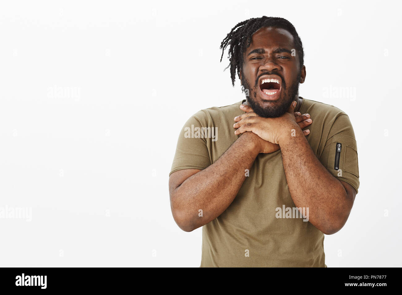 Portrait of unhappy displeased attractive darkskinned male, squeezing