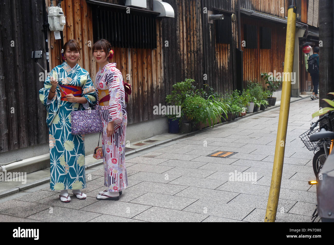 Girls dressed in rental kimono with selfie stick, Gion, Kyoto, Japan. No MR or PR Stock Photo
