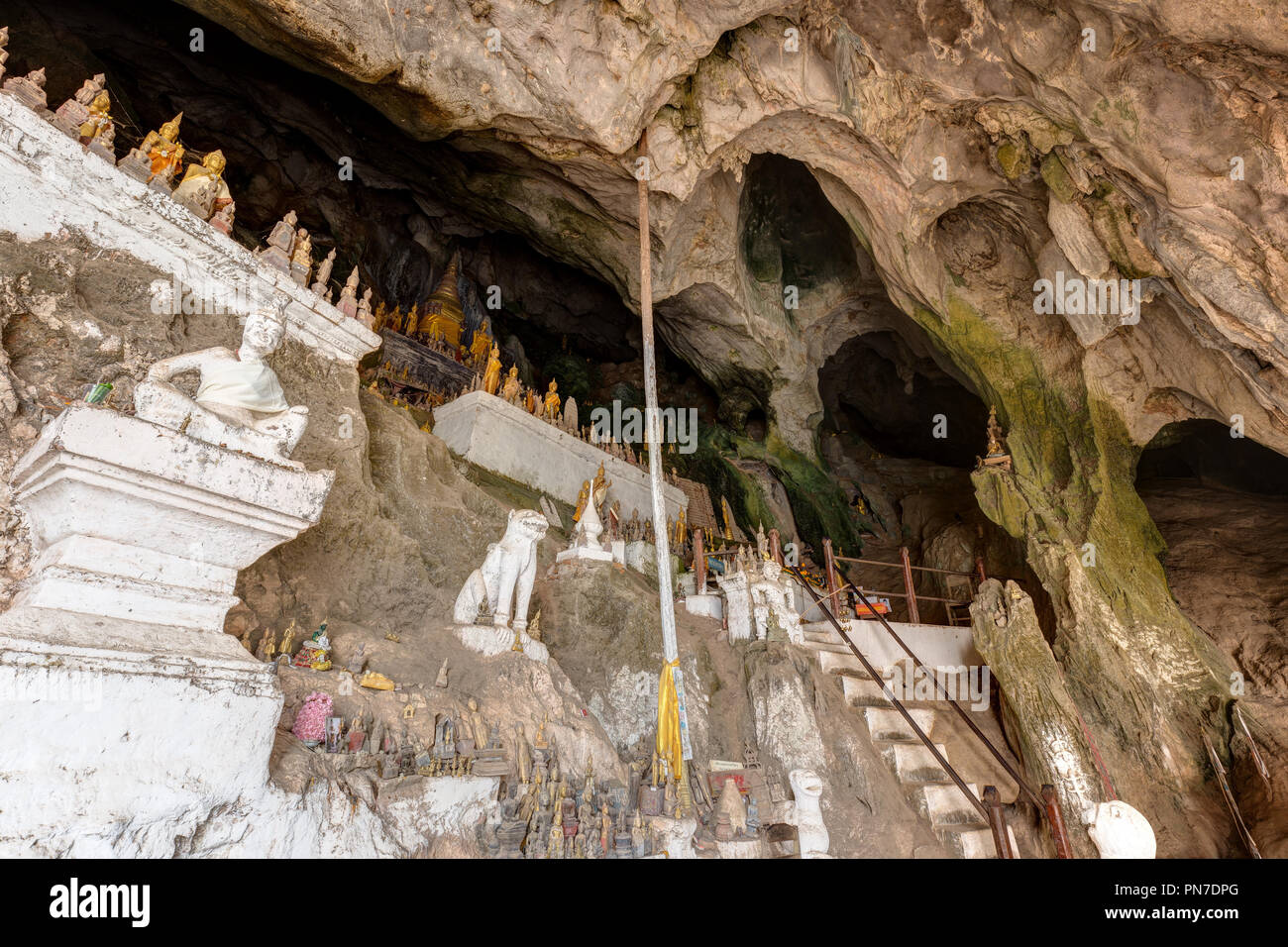 Hundreds of old and faded Buddha statues inside the Tham Ting Cave at the famous Pak Ou Caves near Luang Prabang in Laos. Stock Photo