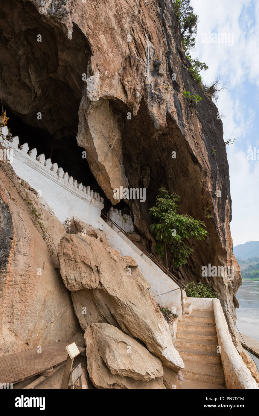 Limestone cliff and stairs at the entrance to the Pak Ou Caves near Luang Prabang in Laos. Stock Photo