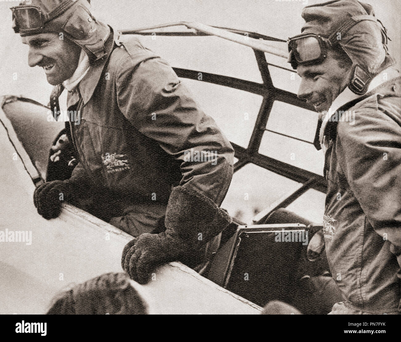 A. E. Clouston, right, and Victor Ricketts arriving in Croydon Airdrome, March 26, 1938 after flying from England to New Zealand and back in just under eleven days. Air Commodore Arthur Edmond Clouston, 1908 – 1984.  British test pilot and senior Royal Air Force officer.  From These Tremendous Years, published 1938. Stock Photo