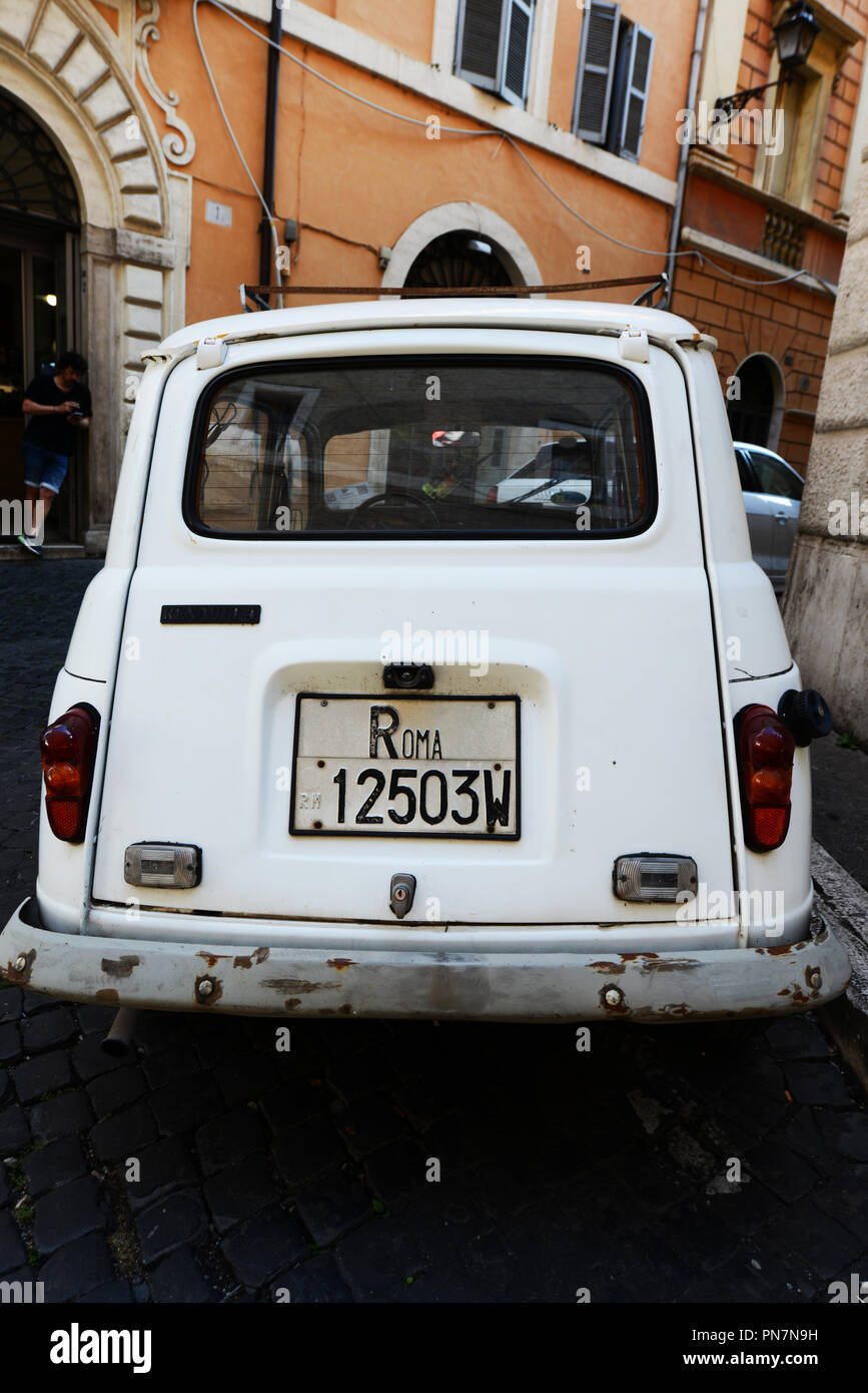 An Old Renault 4 car with an old Roma license plate. Stock Photo