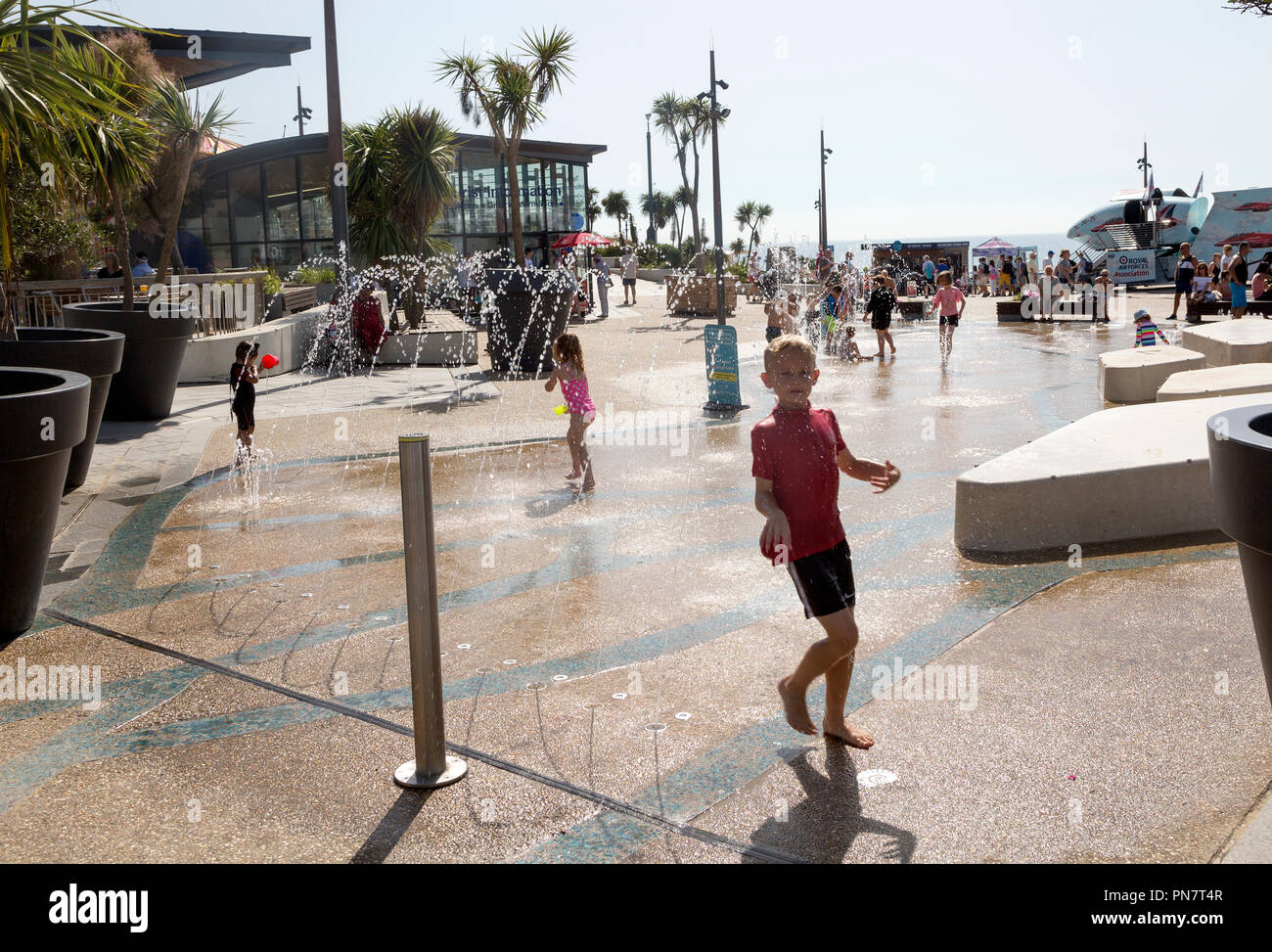 Children playing in water fountain spray near the pier, Pier Approach